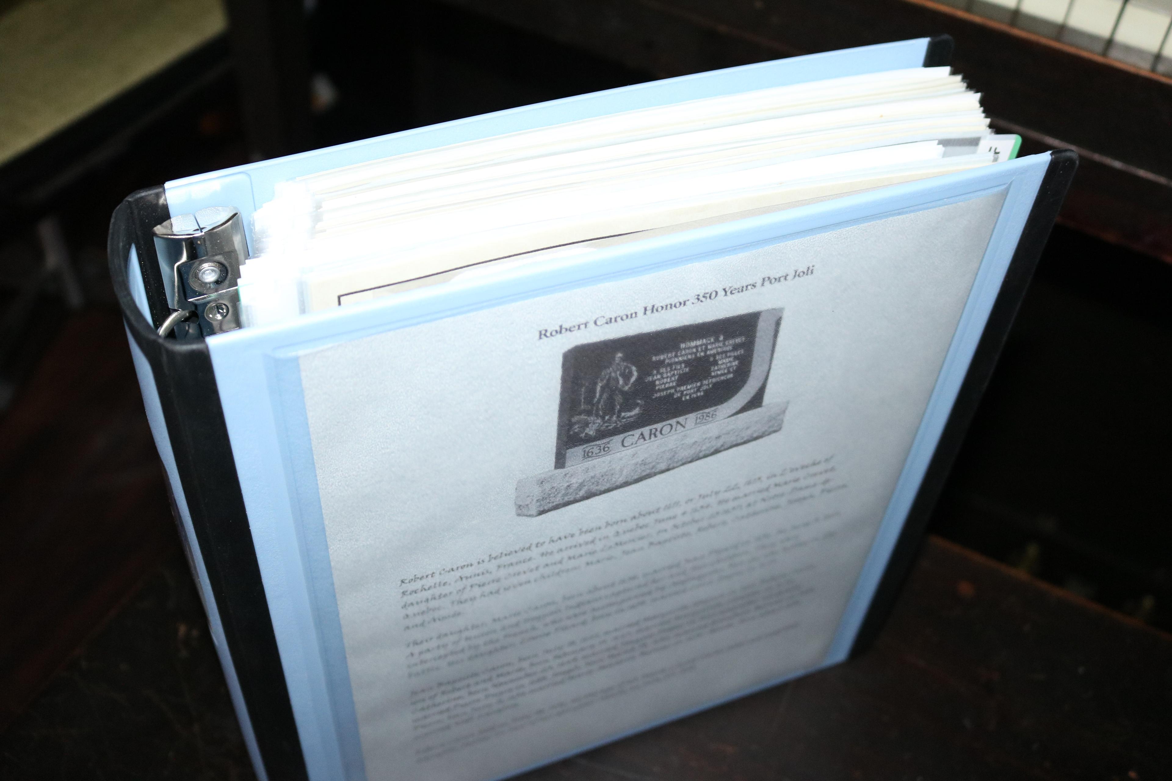 Genealogy binder standing upright with Robert Caron Port Joli cover